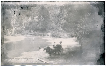 11 W (5) Horse drawn carriage beside a river bed.