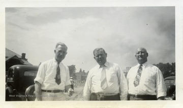 Photo from WVU College of Mineral Resources Scrapbook. Photo of three unidentified men standing outside.