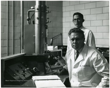 A portrait of Dr. Voelz, foreground, with a young man standing behind him.