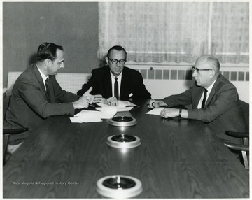 A photograph of Paul Kent (left), Chet Arrents (center) and Ray Shaefer (right), Chairman of Industrial Engineering, seated at a table.