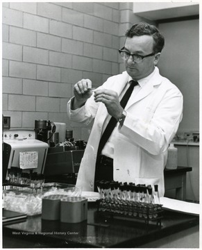 Man working with chemicals in a laboratory.