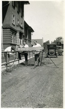 Three mining students experiment with equipment.