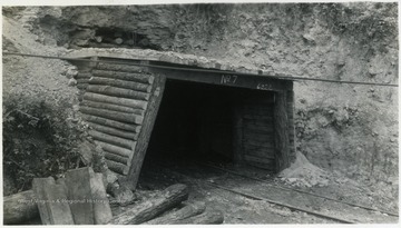 A photograph of railroad tracks leading into a tunnel.