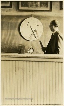 A photograph of an instructor working with a piece of laboratory equipment.