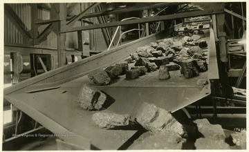 A photograph of coal moving through the manufacturing process. 'Island Creek Coal Sales Co., Cincinnati, Ohio; The following cars of Pocahontas coal were shipped today for account of; 4-Point Pocahontas Coal'