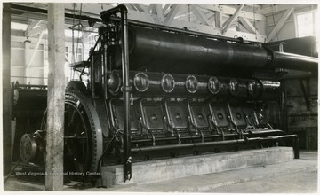 A photograph of an industrial engine in a warehouse. 'D.L. Scott'