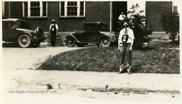 A photograph of men outside of a building wearing safety masks.