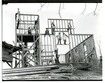 Workers building frames for a house near Clarksburg.