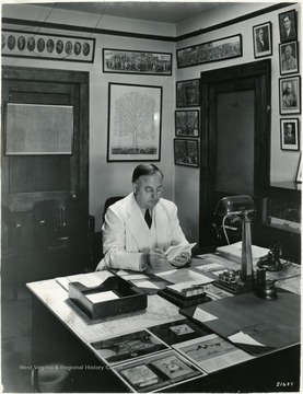 A photograph of Koepler at his desk. 'Notice; Permission is granted to reproduce this photograph only on condition that each reproduction shall bear the following credit line; Photograph by Norfolk and Western Railway'