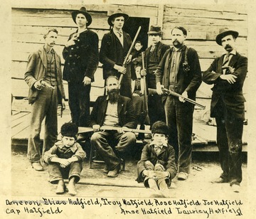 In The Doorway:  Levicy Hatfield (Devil Anse's Wife), sitting.   Mary (Devil Anse's Daughter, Back Row (left to right):  Damron (hired hand), Elias Hatfield (son), Detroit or Troy Hatfield (son), Joe Hatfield (son), Cap Hatfield (son), Bill Borden (store clerk and friend.) Front Sitting (left to right):  Tennyson or Tennis Hatfield (son), Devil Anse Hatfield, Willis Hatfield (son.
