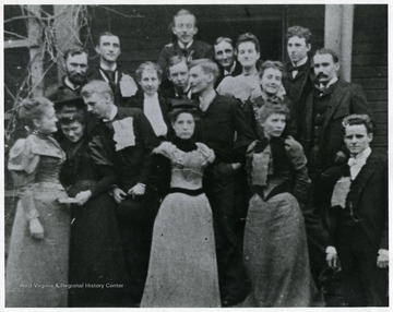 'Corn bread breakfast at "The modest brown cottage," A.B. Fleming's home in Charleston, W. Va. While Governor, center back; Walton Miller; 2nd row: Alec Quarrier, George McClintic, Mary Long, George Summers, Brad Clarkson, Minnie Owings (married Clarence Watson), Gypsy Fleming, Bob Ewing, Harrison B. Smith; Front Row: Ida Fleming, neice of Mrs. P.C. Gallaher, Fontaine Brown, Miss Caldwell, Bess Summers, Jim Ewing'