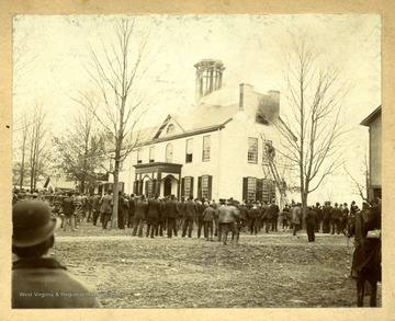 'This honored old institution was founded in 1814, and was the direct predecessor of West Virginia University.  The first sessions of the University were held in this building, which stood where the Morgantown Public School now stands.  It was later used as the Morgantown public School, until it was destroyed by fire in 1896.'