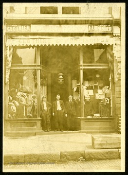 Three men stand in front of Tetrick General Store of Emory Tetrick, the store owner, Emory is the center figure.