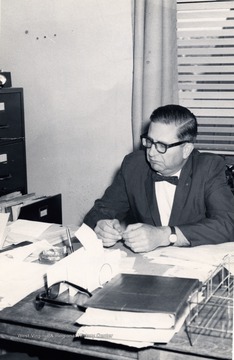 A photograph of Senator Moreland seated at his desk.