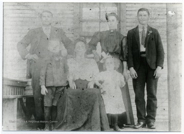 '#7 Hitchman Row House, Hitchman Coal Mine, Benwood.  Standing, Left to Right, Stephen Nyers, Sr.,  unknown couple, front row child Stephen Nyers, Jr; seated Mrs. Stephen Nyers, Sr. and daughter, Mary.'