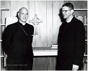 A photograph of Reverend Rogan (right) standing with another church official.