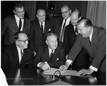 A photograph of Senator Randolph (far right) gathered with Governor Smith (seated, center) and others.
