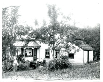 A family just outside of the house, possibly taken in Webster County, W. Va..