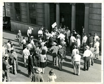 The caption reads: Clarksburg Unions Unite to Win Strike--A 1946 picket line manned by members of union affiliated with the Harrison County Central labor Union, was successful in obtaining a new contact for Typographical Union 372 with a Clarksburg newspaper publisher.  Because of labor's united support the strike was of short duration.'