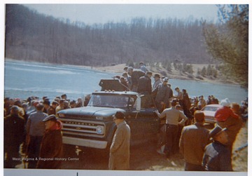 People gather near the Deegan Lake, Bridgeport, W. Va..