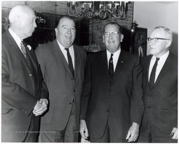 A photograph of Senator Randolph (second from left) standing with Judge Charles G. Baker (left), J. W. Ruby (second from right) and another unidentified individual. 
