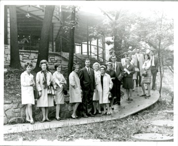 Grace Martin Taylor near center stands on the left of a man in the middle.
