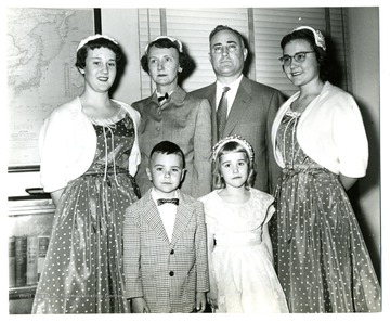 'Mr. Robert M. Snyder was sworn in on March 28, 1955, as director of the FOA Mission in Afghanistan.  Shown in pictures are Mr. and Mrs. Snyder with their children, left to right: Margaret; Robert, Jr.; Shirley and Rebecca.'