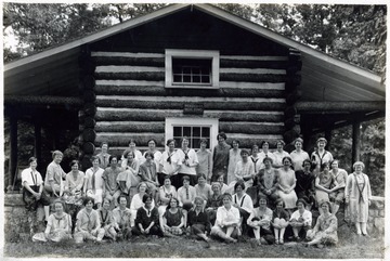 A photograph of the Association of Women Students in front of the Webster County Building at what appears to be Jackson's Mill in Lewis County.