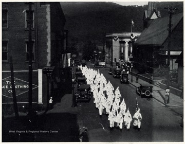 A photograph of the Klan engaged in a march down a city street.