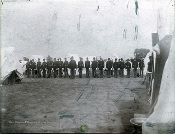 A photograph of a Guard unit lined up in a camp. 'Gen. Clarence L. Smith commanded the W. Va. Nat'l guard (father of C. E. Smith)'