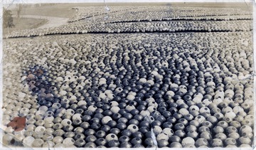 A large collection of bomb shells in a field.