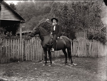 A portrait of an elderly bearded man on horse back taken outdoor in Helvetia, W. Va.