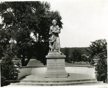 Statue of Madonna of the Trail located in Wheeling on U.S Rt. 40. A Daughter's of the American Revolution statue. p. 114. 'N.S.D.A.R Memorial To The Pioneer Mothers Of The Covered Wagon Days.' 