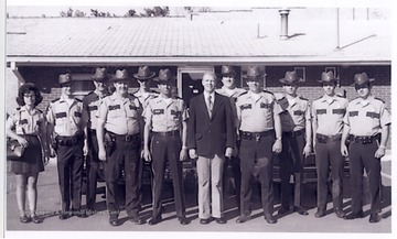Mayor Carl Furbee, Jr. is surrounded by police officers; the chief of Police John Diamond stands right to Mayor Furbee.