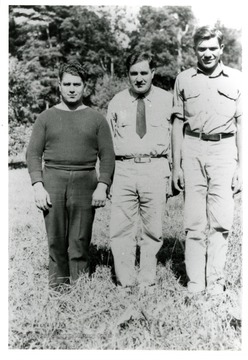 Three males in photo, two are in uniform and the other appeared to be in civilian clothing.