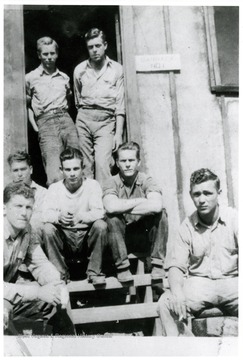 Several camp friends pose around the entry way of the Barrack No.1.