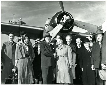 "Dr. Frank N. D. Buchman welcomes the first European arrivals to the World Assembly for Moral Re-Armament at Los Angeles Airport.  Left to right: Dr. Erwin Stein, Minister of Education for Hesse, Germany; Countess Carlo Lovera di Castiglione, Rome; Dr. Frank N. D. Buchman; Count Carlo Lovera di Castiglione, Rome; Mr. Robert Daum, Lord Mayor of Wuppertal, a Ruhr industrial city.  Forty years Socialist Trade Union Leader; Dr. Katzenberger, Chief of the Press Bureau of Minister President of North Rhine-Westphalia (Ruhr), Mrs. Knud Kristensen, Leader of Farmers' Party of Denmark, Prime Minister from 1946-1947; Mr. George Eastman, President, Security Materials Company, Past President Los Angeles Chamber of Commerce."  The World Assembly for Moral Re-Armament met in California June 2-3, 1948