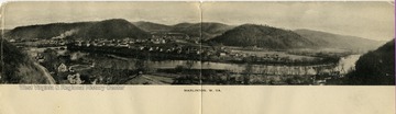 Postcard photograph of a wide angle view of Marlinton and the Greenbrier River flowing through the town.