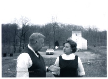 Jesse Stuart and Maryan Dahmer talk in a church yard.