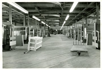 'Adamston Flat Glass--top floor cutting room, stalls at left side far end were #1 to #15 just in picture & right side would be #16 to far right #32.  My stall was #7 just out of sight on left side behind the center elevator.  My father Frank Duez was #10 beside elevator behind water fountain & heater.  The way it looked to me when I became & app. in 1962.  I was working in behind the elevator on right side in #21....' (Dick Duez)