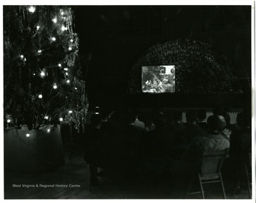A view of Christmas Party, shown here is students watching a Christmas movie in the theater.
