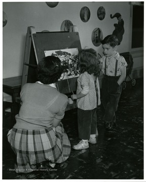Students of Nursery Education work on painting with students at Nursery School.
