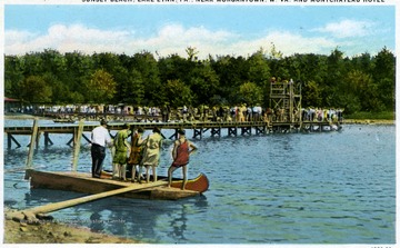 A view of crowds on the piers and in a boat.  The Sunset Beach, Lake Lynn, Pa. located near Morgantown, W. Va. and Montchateau Hotel.