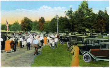 A view of picnic grounds at Sunset Beach in Lake Lynn, Pa.; the site is full of people and automobiles.  The Sunset Beach is located near Morgantown, W. Va. and Montchateau Hotel.