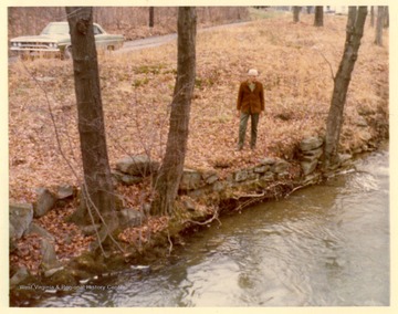 Thomas Yoke points out the site of dam across Aaron's Creek at Hawthorne's Rail Factory.