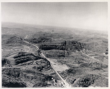 View looking down on Route 50 between Clarksburg (barely visible at the top of the photograph) and Bridgeport prior to the construction of Interstate 79.  Baltimore and Ohio Railroad line visible on the right portion running parallel to Route 50.  Currently, Interstate 79 intersects Route 50 near the center of the photograph.