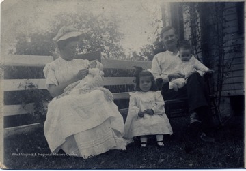 On the back of the photo: 'Mrs. Louise Fairfield with son James Mildred Fairfield and Lee Hogan with his son Fisher and daughter Helen. Lee Hogan was a veteran printer of the Morgantown Newspaper.'