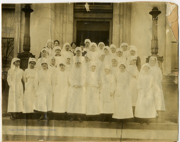 Group of women dressed in white uniforms, probably Red Cross workers/nurses. An arrow points out one woman identified as "Mother".