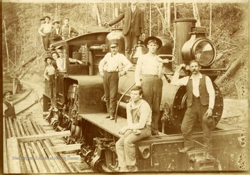 On the back of the photo: 'Sunday at Montes. D. D. Brown, second one back in engine window.'