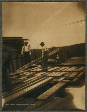 'The above picture is men loading lumber in the Thorndale, Pa., sawmill of David Dare Brown I which was the last operation he had. This is one of the places where M. M. Brown and D. D. Brown got their logging, saw mill, and selling experience.' 